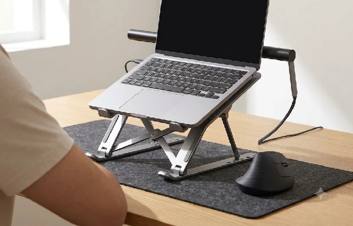 Cheap office gadgets for posture: laptop stand elevating screen to eye level beside vertical mouse