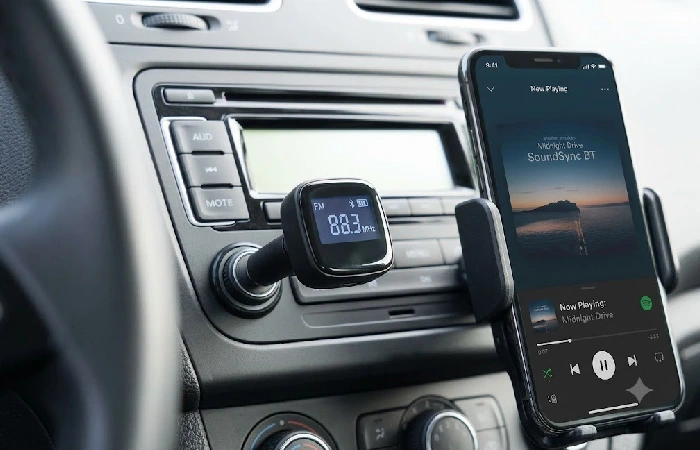 Bluetooth FM transmitter plugged into a car's 12V socket with display