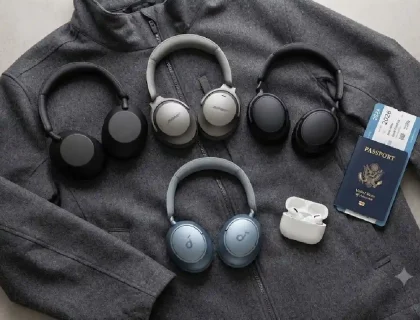 Best noise cancelling travel headphones for 2026 laid out beside a boarding pass
