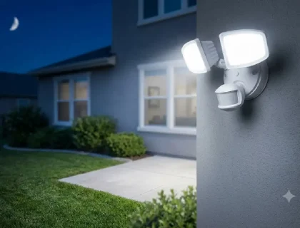 Outdoor motion sensor light mounted on a home exterior at night